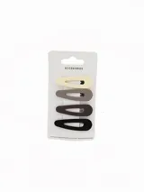 Set de cuatro hebillas tipo clip para el pelo en tonos neutros degradados, desde crema hasta negro.