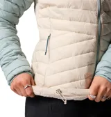 Campera acolchada Columbia modelo Powder Pass, con diseño bicolor en tonos celeste y beige. Presenta cuello alto, cierre frontal completo, mangas largas y bolsillos laterales con cierre.