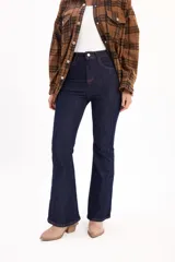 Jean de tiro alto con corte ajustado en la parte superior y botamanga oxford. Confeccionado en denim azul oscuro, presenta costuras verticales visibles a lo largo de la pierna que estilizan la silueta.