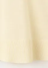 Jersey de punto fino color amarillo claro, con escote en V y manga larga.