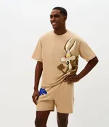 Pijama corto de algodón en color beige, compuesto por remera de manga corta con corte boxy y gran estampa frontal del Coyote de Looney Tunes, y bermuda haciendo juego con estampado lateral.