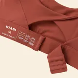 Sujetador deportivo de sujeción fuerte color marrón, con diseño de espalda cruzada y tirantes ajustables.