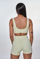 Conjunto deportivo compuesto por un top de escote redondo con logo estampado y un short de tiro alto con diseño ajustado.