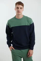 Sweater deportivo de hombre con escote redondo, diseño colorblock con la parte superior en gris claro y el cuerpo y mangas en negro. Presenta puños y cintura elastizados.