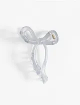 Broche para el pelo con forma de moño transparente, de plástico rígido.