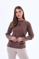 Remera de manga larga en color marrón con textura acanalada y un pequeño corazón bordado en el centro del pecho.