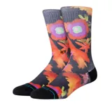 Par de medias Stance con estampado de flores en tonos naranja, violeta y verde sobre fondo negro.