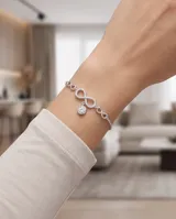 Pulsera de plata 925 con diseño de símbolos de infinito pavé de circonias y dije colgante circular con circón central.