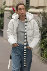 Anorak acolchado de corte corto, resistente al agua y al viento. Cuenta con cuello subido, capucha ajustable con cordones, cierre frontal con cremallera y bolsillos laterales con forro polar. El bajo es ajustable mediante cordones elásticos.