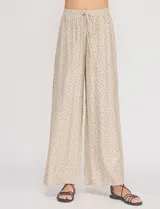 Palazzo de tiro alto color beige con estampado de lunares, cintura elastizada con cordón de ajuste y corte de pierna ancho.