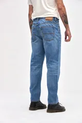 Jean de corte tapered, holgado en la cadera y levemente ajustado hacia los tobillos, con tiro medio y cierre frontal con botones.