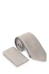 Corbata verde oscuro con estampado floral y pañuelo de bolsillo a juego.