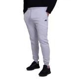 Pantalón de jogging gris melange con cintura elástica y cordón ajustable, puños en los tobillos y logo bordado en la pierna izquierda.