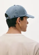 Gorra de visera curva color celeste, confeccionada en tejido suave con diseño clásico de paneles.
