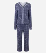 Pijama largo estilo americano compuesto por una blusa de manga larga con escote en V y cierre frontal de botones, y un pantalón con cintura elástica. Ambas piezas presentan un estampado de flores pequeñas sobre fondo azul oscuro con detalles de ribetes blancos.