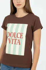 Remera de algodón color beige, de manga corta con vuelta, cuello redondo y corte holgado. Cuenta con un estampado frontal con la inscripción "Manhattan New York East Coast" en tonos celestes.