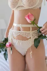 Portaligas color crema con detalles de encaje en la cintura y tiras regulables.
