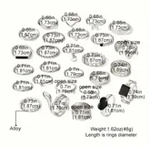 Set de 27 anillos plateados con diferentes diseños: lisos, con forma de serpiente, con corazones, con piedras negras, con forma de mariposa y con eslabones.