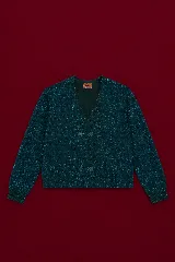 Cardigan cruzado de tejido con lurex color verde oscuro, con escote en V y botones decorativos con forma de flor.
