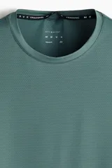Musculosa deportiva H&M Move de corte estándar, color verde oscuro, con tecnología DryMove para absorción del sudor, cuello redondo y sisas amplias.