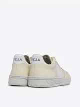 Zapatillas Veja V-10 color crema con logo lateral en blanco. Fabricadas con J-Mesh, un tejido de yute y algodón.