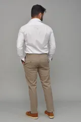 Pantalón de gabardina color azul marino, de corte ajustado y tiro medio, con cierre y botón frontal.