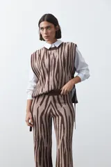 Pantalón de punto jacquard con diseño animal print, de corte recto y pierna levemente amplia, confeccionado en tejido flexible.