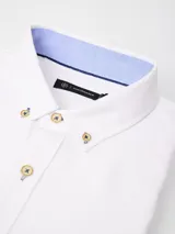 Camisa de manga larga marca Cuatro Ases, confeccionada en tejido oxford color blanco. Presenta cuello con botones, detalle de contraste en color celeste en el interior del cuello y botones con costuras en contraste.