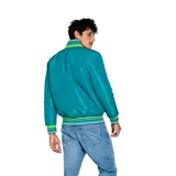 Campera reversible Umbro color turquesa con cuello, puños y dobladillo a rayas verdes, azules y blancas. Tiene cierre frontal y logo bordado en el pecho.