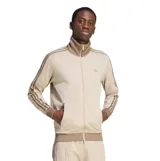 Campera deportiva Adidas modelo Beckenbauer, de color beige con las icónicas tres tiras en tono tostado en las mangas. Presenta cuello alto, cierre frontal completo y bolsillos laterales con cierre.