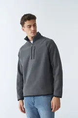 Buzo polar de algodón azul marino con cuello elevado, logo estampado, bolsillo frontal con cierre y medio cierre frontal.