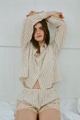 Shorts de tiro medio y cintura elástica, confeccionados en mezcla de algodón y viscosa con diseño de rayas verticales. Presenta el bajo acabado con aplicación de encaje y bordados en contraste.