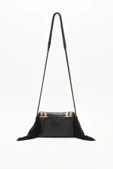 Cartera bandolera negra de cuero con diseño trenzado y apliques dorados en el frente, flecos de cuero en la parte inferior y correa trenzada.