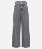 Pantalón de jean color gris lavado, con corte wide leg de piernas amplias y cintura baja. Presenta detalle de tachas metálicas a lo largo de las costuras laterales, cierre frontal con botón y bolsillos funcionales.