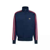 Chaqueta deportiva Adidas Firebird TT C color azul marino, con cierre frontal y cuello alto. Presenta las tres franjas características de Adidas en las mangas, combinando rojo, blanco y azul. El logo del trébol de Adidas está bordado en dorado en el pecho.