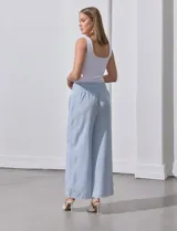 Pantalón largo de poliéster color beige con rayas verticales, pretina ancha elastizada en punto smock y pierna ancha.