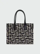 Bolso tote pequeño Balmain modelo B-Army, con monograma geométrico en blanco y negro, asas cortas de cuero negro y logo Balmain en relieve.