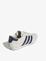 Championes Adidas Taekwondo Lace color crema con detalles en azul marino.