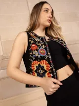 Chaleco negro con bordado floral multicolor, sin mangas y corte recto.