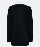 Chaqueta de tricot color negro con interior de pelo sintético blanco, corte recto, manga larga y bolsillos frontales. Marca Blue Steel.