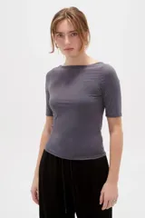 Remera de poliamida color gris, de manga 3/4, calce al cuerpo y cuello bote.