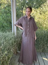 Camisa verde militar de lino italiana con botones de nácar, corte holgado, cuello camisero y mangas cortas con dobladillo.