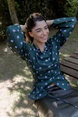 Camisa verde con lunares violetas, cuello clásico, mangas abullonadas y lazos laterales para ajustar.