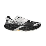 Championes de trekking Hoka modelo Speedgoat 7, en combinación de color blanco y negro, diseñados para running y senderismo con suela Vibram.