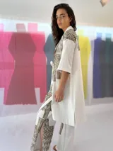 Blazer/Vestido Ligamento blanco de lino y algodón con estampado exclusivo en cobre laminado. Tiene solapa smoking y se cruza con lazos en la cintura.