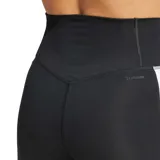 Calza deportiva Adidas negra de tiro alto, corte semi oxford (acampanado en la parte inferior), con las tres franjas blancas características a lo largo de las piernas.