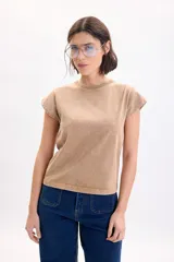 Remera de manga corta con efecto lavado acid wash en color beige, con cuello redondo en rib y mangas con dobladillo estructurado.