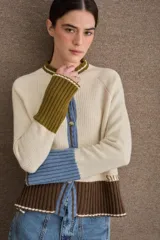 Cardigan de punto con diseño color block en tonos bordó, verde oliva y beige. Presenta cuello redondo con detalle en celeste, cierre frontal con botones y puños acampanados en color beige.