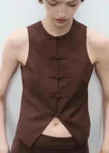 Chaleco marrón sin mangas con cuello redondo y cierre frontal con botones forrados.