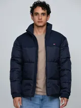 Campera puffer azul marino de cuello alto, acolchada y con cierre frontal de cremallera. Presenta bolsillos laterales con ojal y el logo bordado de la marca en el pecho.